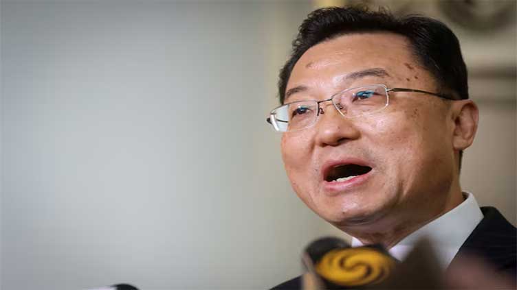 China's US envoy urges end to trade war, but warns Beijing ready to fight